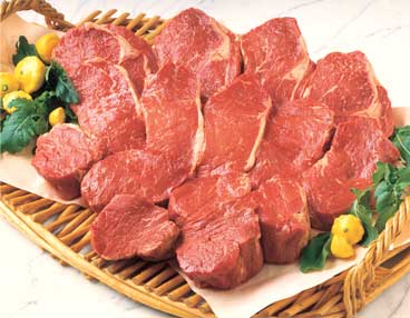 Bamboo platter with 15 cuts of uncooked beef, including ribeye, New York and filet mignon