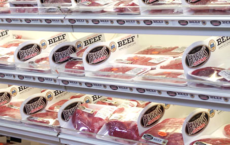 Grocery store meat counter with Harris Ranch case dividers and meat products