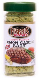 Unopened container of Harris Ranch Zesty Flavor Lemon Garlic Salt. Clear bottle with green lid. Spices are yellow and green.