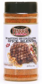 Unopened container of Harris Ranch Roasting and Grilling Spice Blend. Clear bottle with black lid. Spices are red-orange